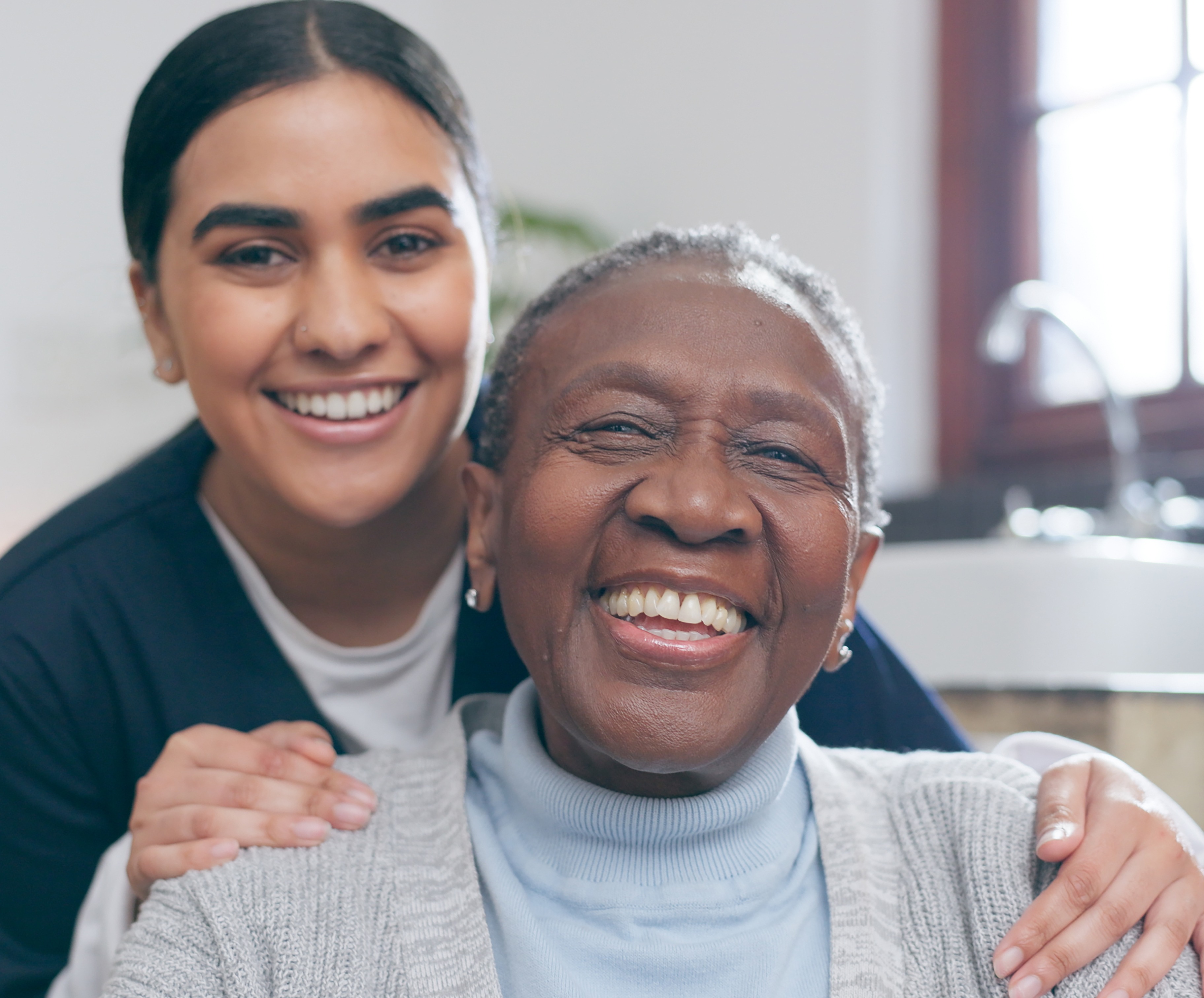 Homecare nursing service and elderly people cardiology healthcare. Close up of young hispanic female doctor nurse check mature caucasian man patient heartbeat using stethoscope during visit